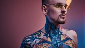 Man with a large neck and chest tattoo before laser tattoo removal treatment